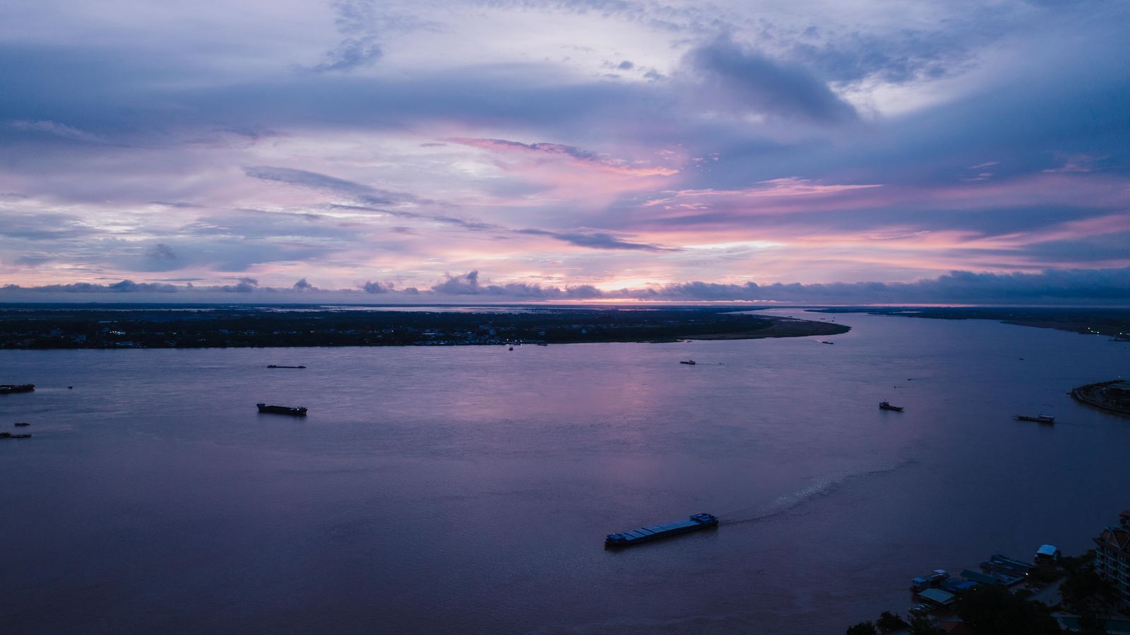 Boats on the Mekong at sunset